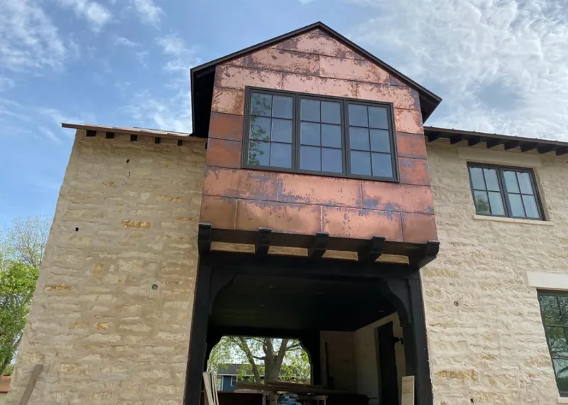 Copper metal panel facade on a stone building for Skylight Installation in Miles City