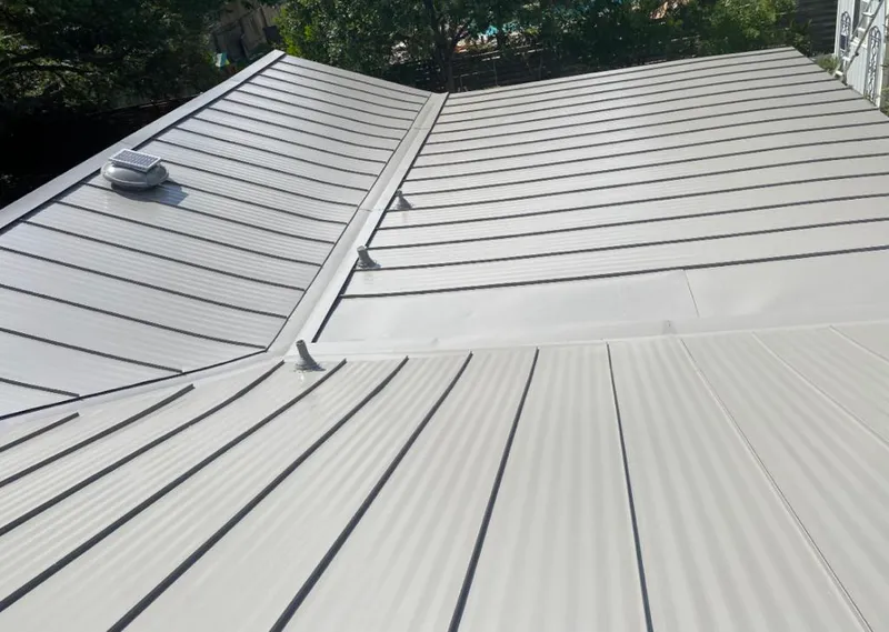 Solar attic fan installed on a metal roof for Roof Ventilation in Miles City