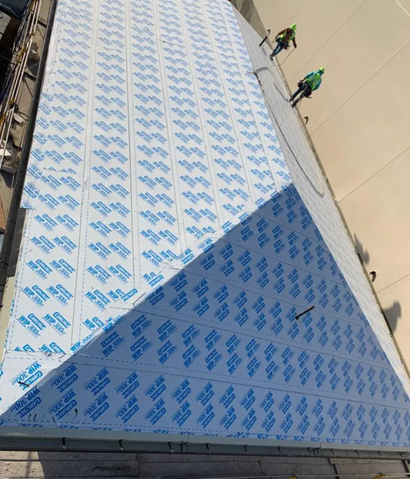 Professional roofers installing underlayment on a metal roof in Miles City